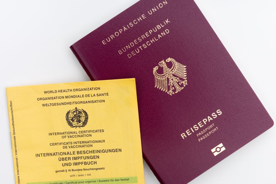 A passport and vaccination certificate ready for travel to Saudi Arabia