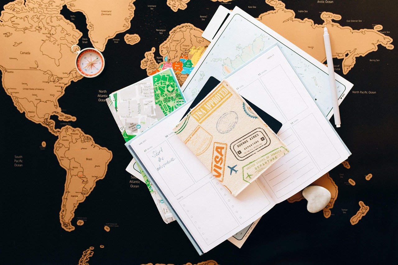 British passport on a wooden desk alongside Saudi Arabia visa documentation and travel itinerary