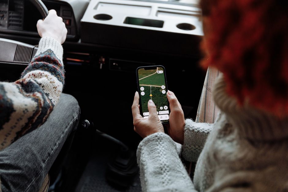 Hands using a navigation app on smartphone