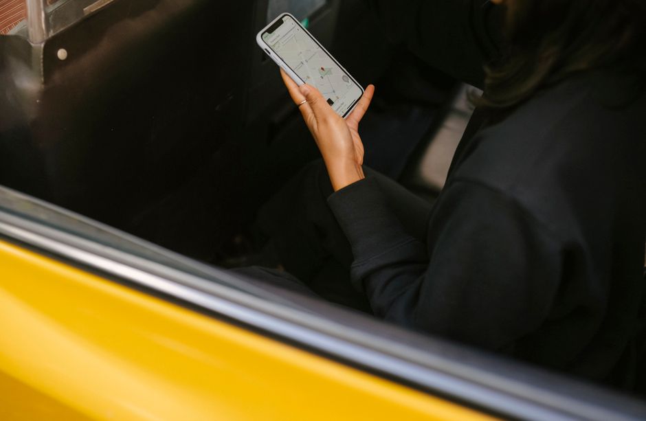 Traveller checking a map app inside a taxi