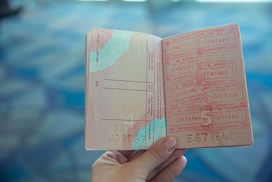 Saudi Arabia passport and immigration visa stamp on wooden table