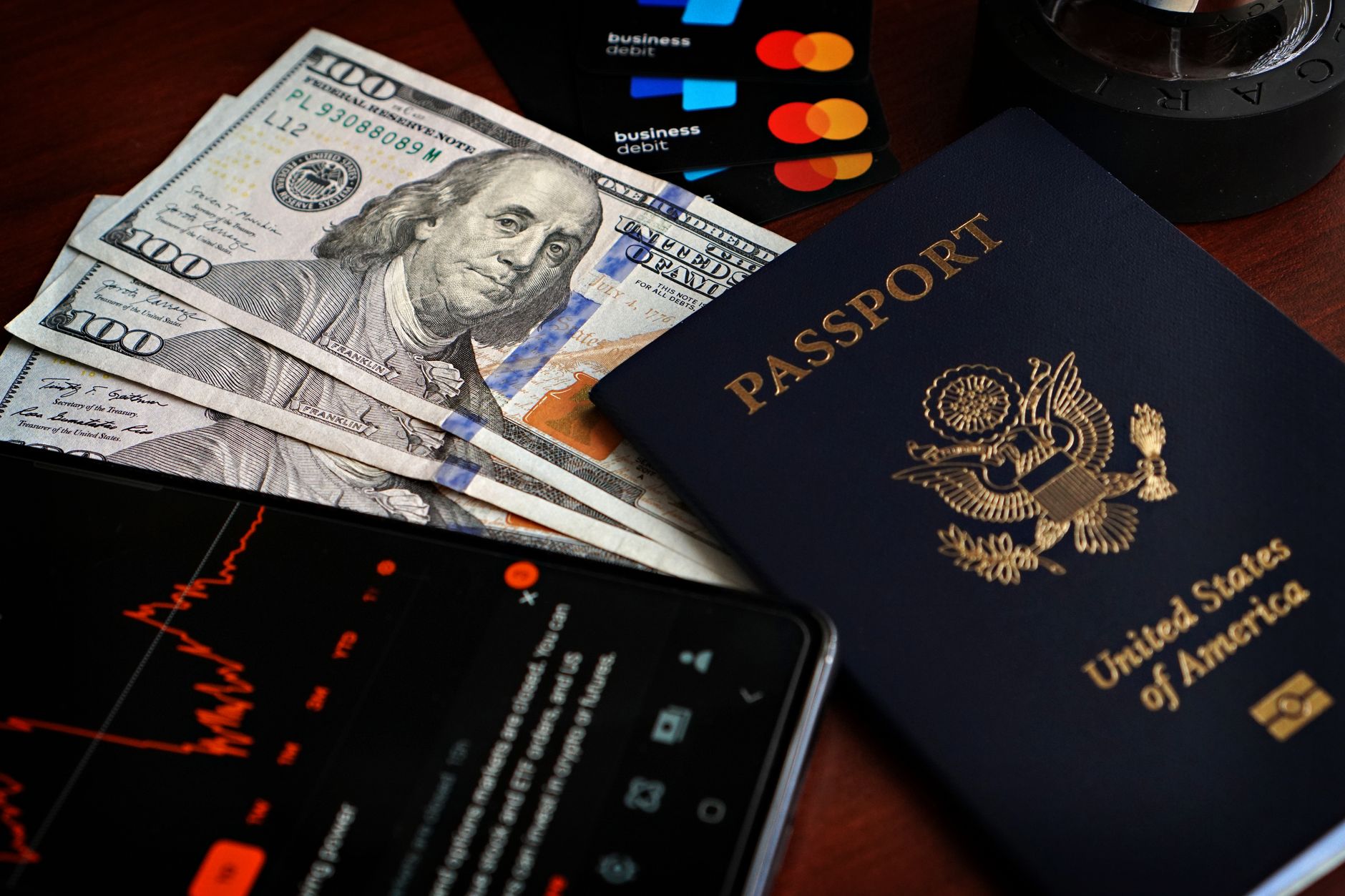 Person holding a smartphone showing a Saudi e-visa confirmation screen, with a passport visible in the other hand