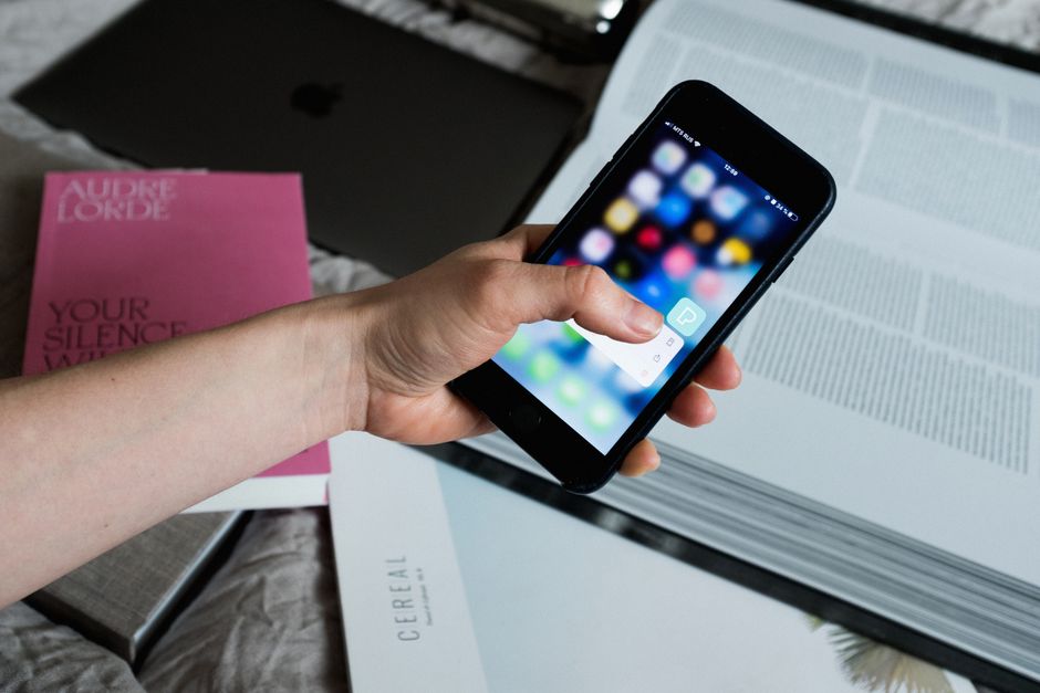 Smartphone with travel booking app on screen, digital travel planning