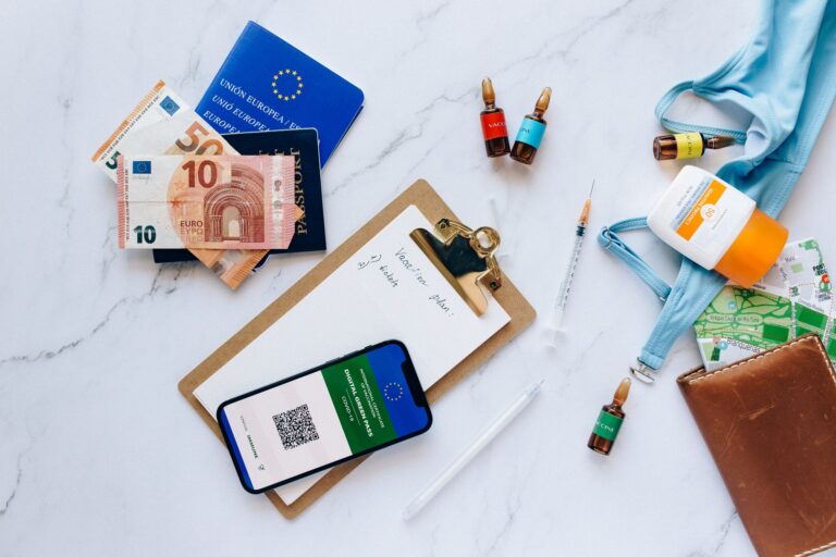 passport, visa printout, vaccination certificate, and phone showing Nusuk app laid out for travel
