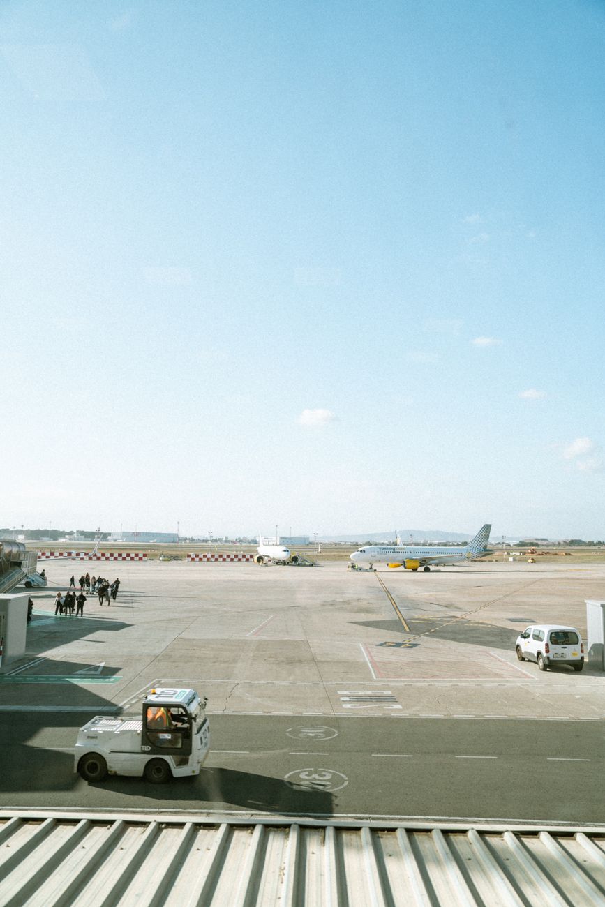 Airport tarmac with aircraft and vehicles