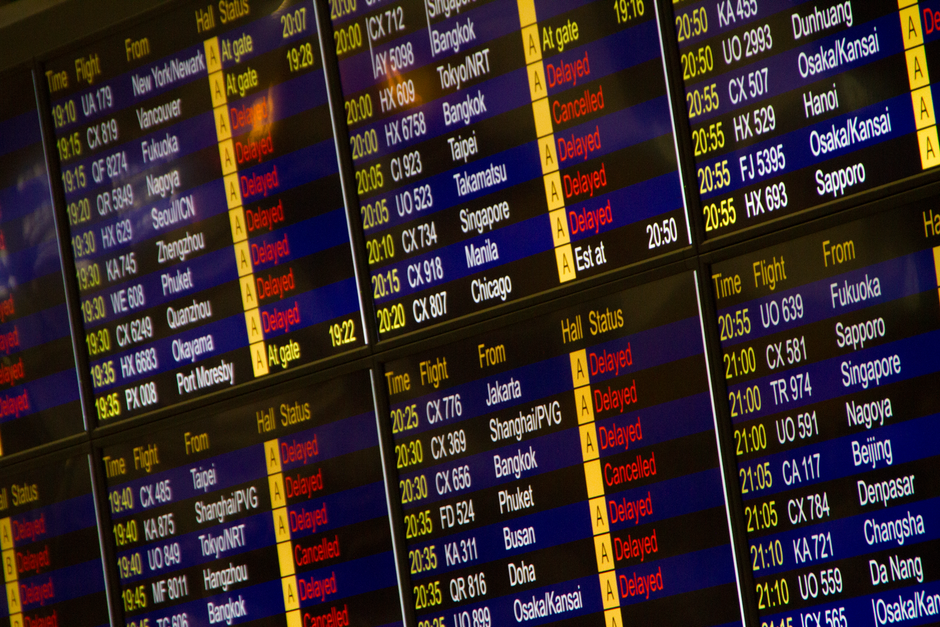 Close-up of digital flight information board showing arrivals and departures at an airport