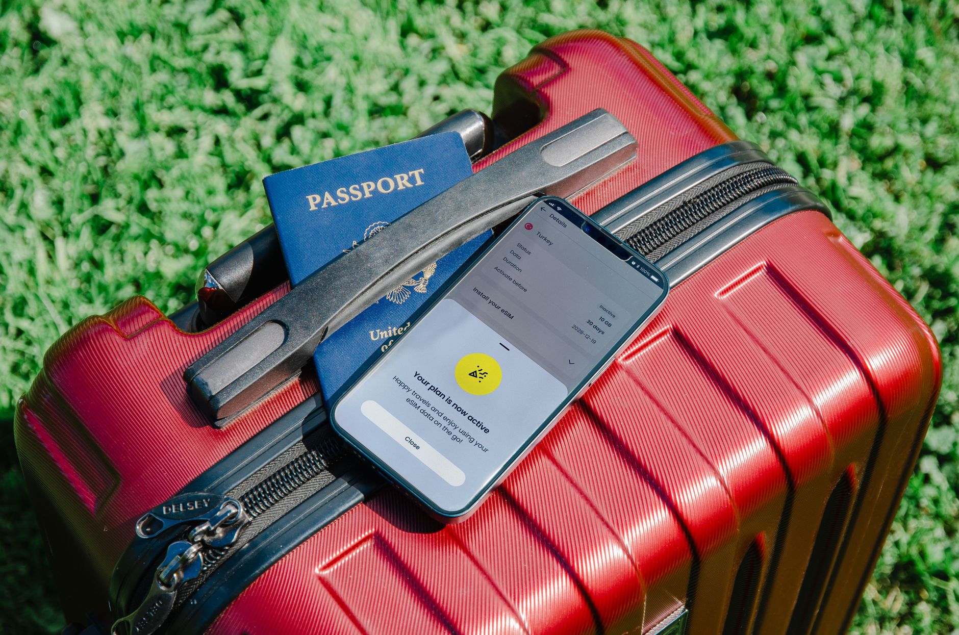 Passport and smartphone on a suitcase for travel planning